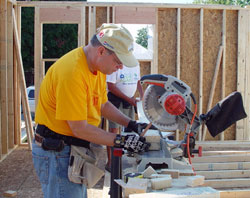 Walt Egenmaier, a parishioner at St. John Church in Daylight, cuts wood during the 2009 Catholic Build for Habitat for Humanity. (Message photo by Mary Ann Hughes)