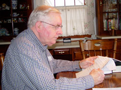 Mel Schapker studies family tree information that he has compiled over the last 25 years. (Message photo by Mary Ann Hughes)