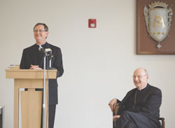Bishop-elect Timothy L. Doherty (left) is introduced at a news conference in Lafayette May 12. He will succeed Bishop William L. Higi (right) as bishop of the Diocese of Lafayette-in-Indiana. (Photo by Caroline B. Mooney)