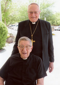 Bishop Gerald A. Gettelfinger stands behind Father Clemens Hut on the day he received the Aging Services of America Volunteer of the Year award. A copy of this photo has been framed and now hangs on the wall in Father Hut’s room.