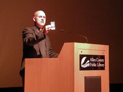 Bishop Kevin C. Rhoades holds a prayer card of Archbishop Fulton Sheen at the screening of the documentary, “Servant of All,” held July 19 at the Allen County Public Library.