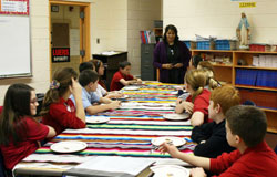 Spanish teacher Cristy Jordan instructs St. Joseph-St. Elizabeth sixth graders on the etiquette of the dining table. She teaches Spanish to fifth- through eighth-grade students at the St. Joseph campus in Fort Wayne.