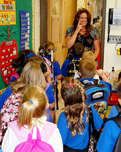 Stacy Kocab with her first-grade students in Kokomo: “I love what I do. I love teaching. ... Faith and work make me more peaceful and less stressed. It makes me feel complete. I felt that I was missing something, and that feeling is sort of gone.” (Photo by Kevin Cullen)