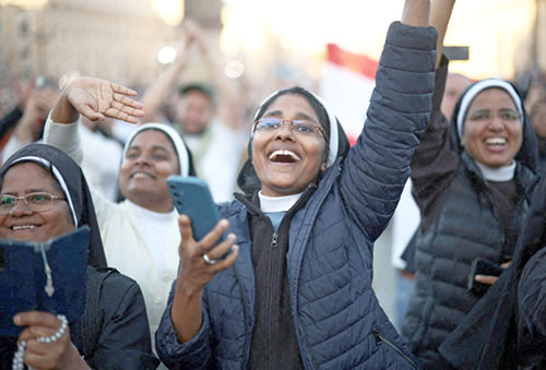 Nuns cheer as Cardinal Robert Francis Prevost, who has chosen the papal name Leo XIV, appears on the central balcony of St. Peter's Basilica at the Vatican May 8, 2025, following his election during the conclave. He is the first American pope in history. (OSV News photo/Marko Djurica, Reuters)