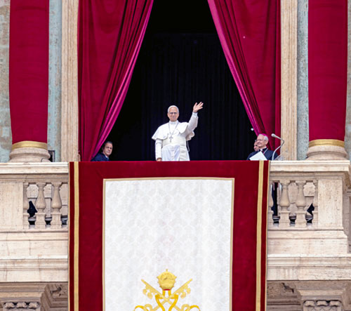 Pope Leo XIV waves to the crowd from the central balcony of St. Peter's Basilica at the Vatican as he leads, for the first time, the midday recitation of the "Regina Coeli" prayer May 11, 2025. (CNS photo/Lola Gomez)