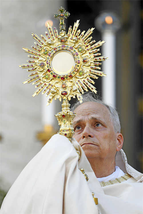Pope Leo XIV looks at the Blessed Sacrament in the monstrance as he leads Benediction outside Rome's Basilica of St. Mary Major after a Corpus Christi procession from the Basilica of St. John Lateran June 22, 2025. (CNS photo/Vatican Media)